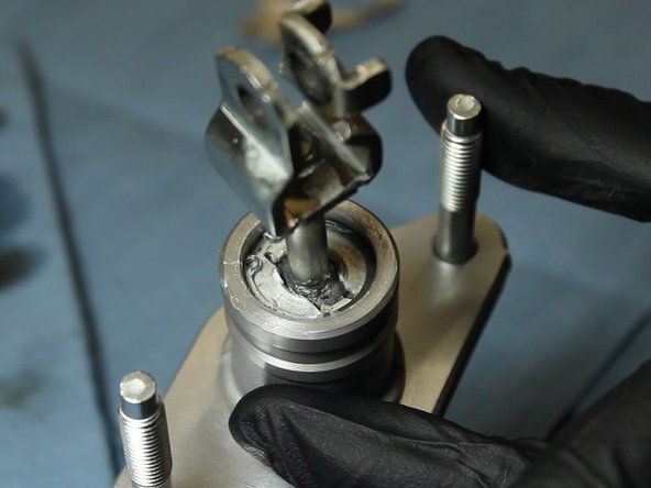 Using the C-clip pliers, insert the OEM rod &amp; fork into the EM1 CMC. The EM1 dust boot is optional.