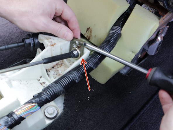 Use a flat screw driver or pry tool and remove the retaining clip on the right side cable.
