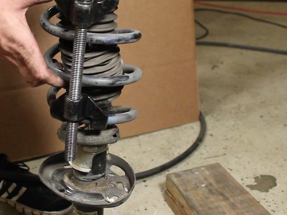 Remove the spring &amp; strut mount from the strut assembly.