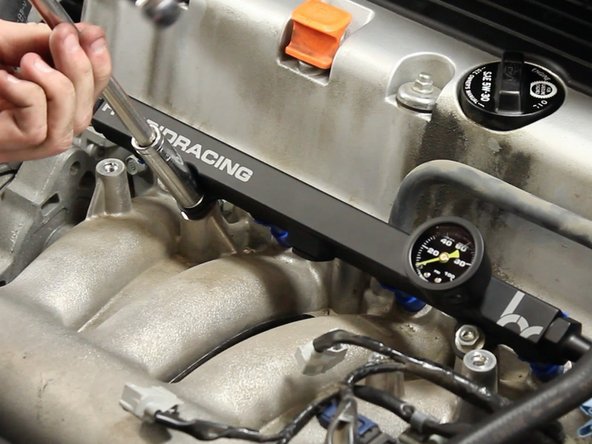 Re-install the 12mm nuts to tighten down the fuel rail.