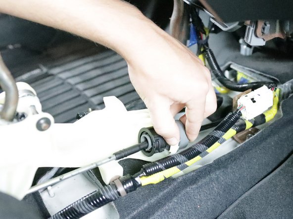 Repeat step 13 on the right-side cable. Spin the lock, slide it out and let it spin back once it is off the shifter. Keep this in mind as you will need to use the same technique to install them onto the new shifter.