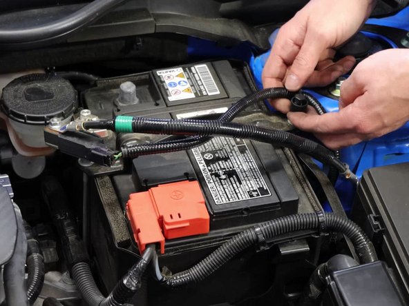 Remove the negative then positive terminal from the battery.