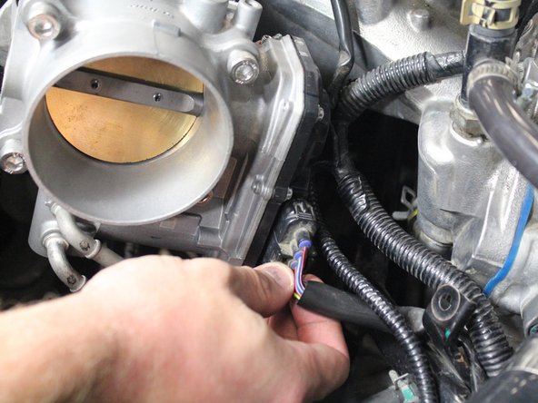 Plug in the throttle body harness to the new throttle body.