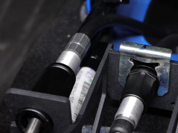 Now install the shifter cable retaining spring clips.