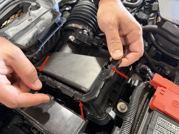 There are a few clips holding the wiring channel to the air cleaner cover. Pop them free with a flat head screwdriver. You come back to the wiring later. If you want to do the wiring now, jump down to the harness steps.