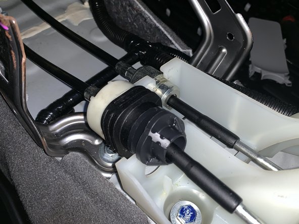 Turn the plastic section of the LH side cable to remove it from the shifter. Once you rotate it, start wiggling it and it will slide out.