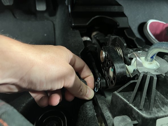 Remove the LH side shifter cable clip and slide the cable off the shifter pin.
