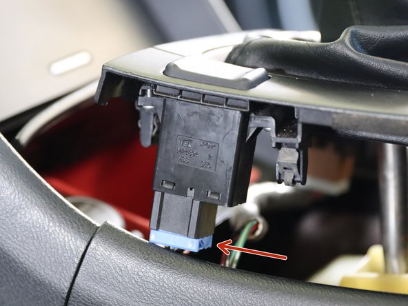 Locate both seat heater connectors and unplug them.