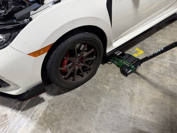 Raise the front of the car, support it properly, and remove the driver-side front wheel.