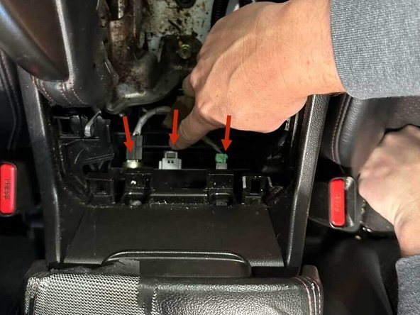 Inside the console cavity, unplug the three connectors.