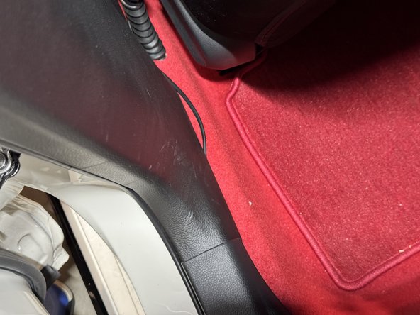 Once the harness slides under the rear sill panel, pull it through and run it along the driver side.