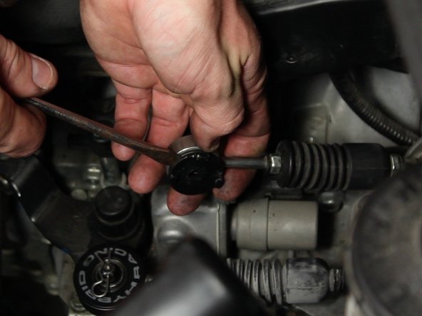 Pry the plastic insert out of the rubber bushing.