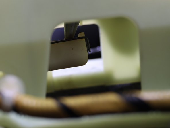 Remove the LH shifter cable from under the shifter. Spread the clip apart and pull it downward away from the shifter.