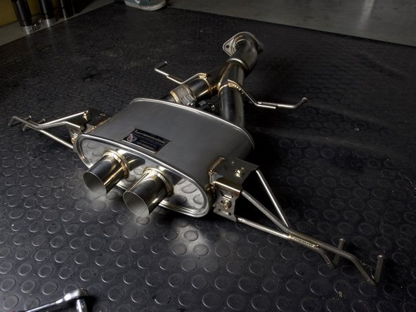 Locate and install the rear muffler brackets with the supplied hardware. Thread both sides together and be sure to keep them loose so the system can be adjusted once on the car.