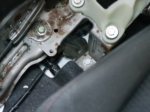 Use a 10m socket and remove the steel bracket located behind the shifter.