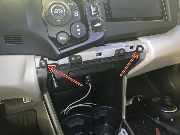 Remove the two screws holding the console sides in place.