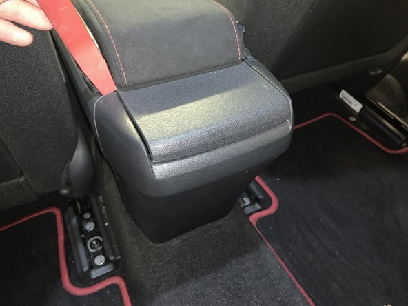 Use a plastic panel pry tool to separate the rear section of the console.