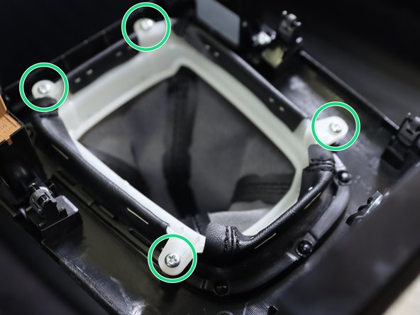 Our shifter works with the factory boot and console. Depending on the offset location and rod height the factory boot may be too short to use a boot collar.