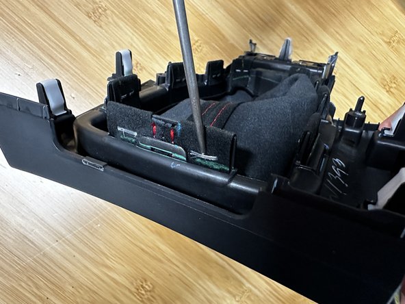 Use a thin pick or flat tipped screwdriver and pry the staples outward.