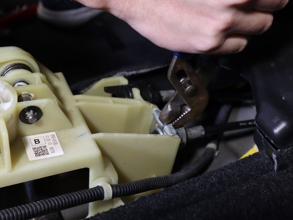 On the front of the shifter, use a pair of pliers and remove the right side shifter cable clip.