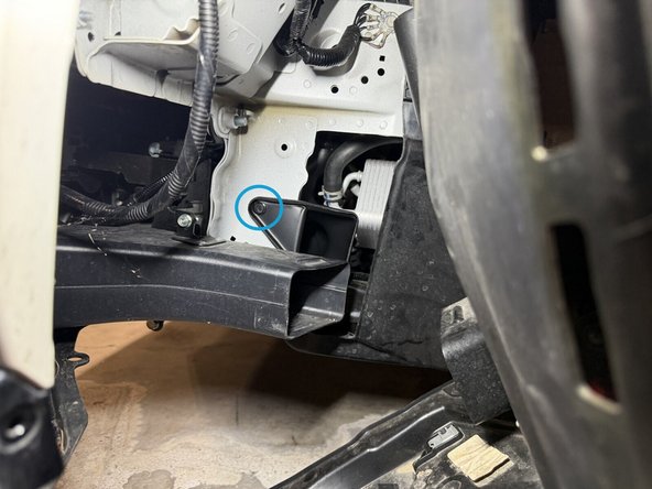 Install the lower section fully behind the bumper beam with the mounting hole pointing down. Once it's in, turn it clockwise until the hole lines up, and secure it. The push-in clip goes into the existing chassis hole.