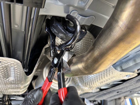 Pull downward to disconnect the exhaust and remove it from the car.