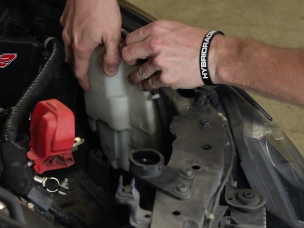 Remove the radiator overflow reservoir.