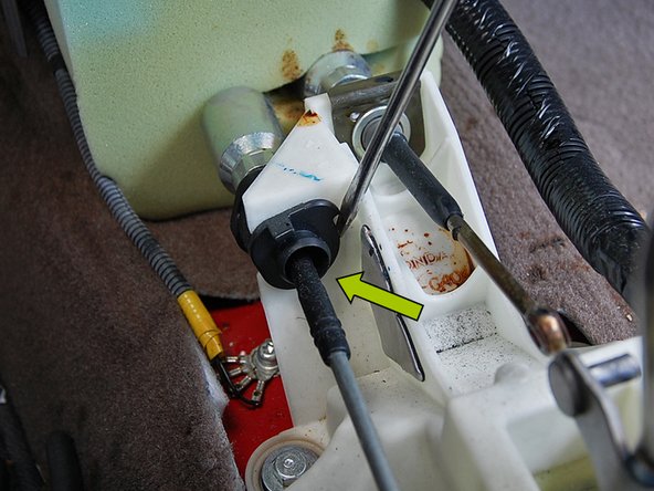 Using a larger flat head screwdriver, pry off of the shifter to rotate the cable base out of the shifter and remove it from the shifter.