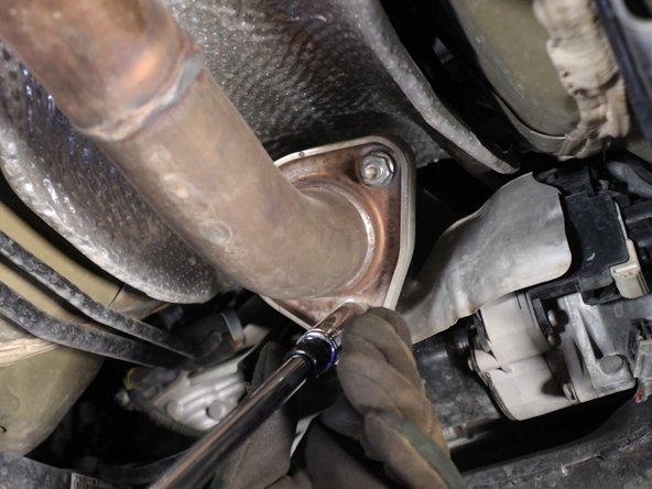 Remove the three bolts holding the exhaust in place. Let it hang down.