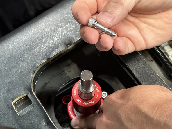 Use the supplied bolts and washers and bolt the shifter base to the transmission.