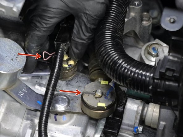 Remove the shifter cable retaining clips.