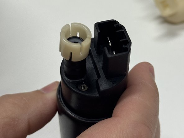 Reinstall the pump spacer on the Hybrid Racing fuel pump.