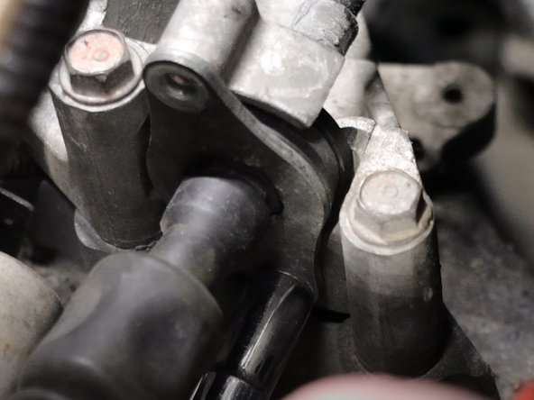 Use a 10mm socket and unbolt the shifter cables from the transmission bracket.