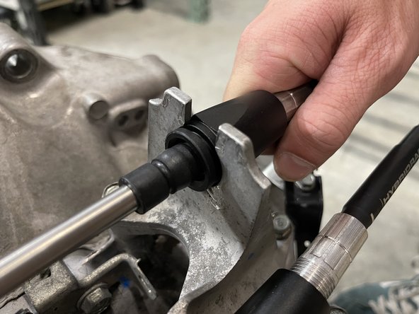 Then, push the shifter cable through the shifter cable bracket and secure it with the supplied C clip.