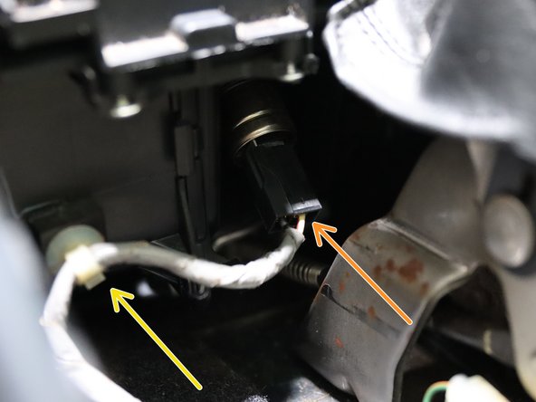 Locate and disconnect the 12v socket connector on the front lower section of the arm rest.