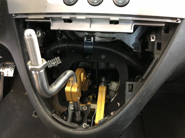 Insert your new Hybrid Racing shifter into the dash by holding the dash center out of the way. This shifter is much smaller so it should slide in easy.