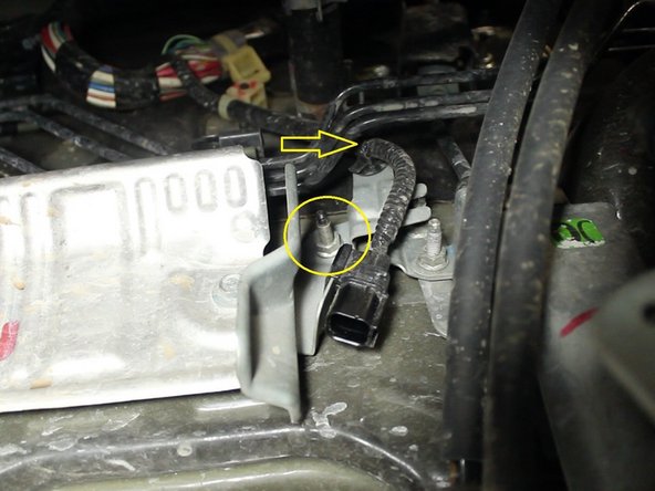 Remove the 10mm bolt attaching the bracket for the primary o2 sensor harness and remove the clip to detach the harness from the bracket.