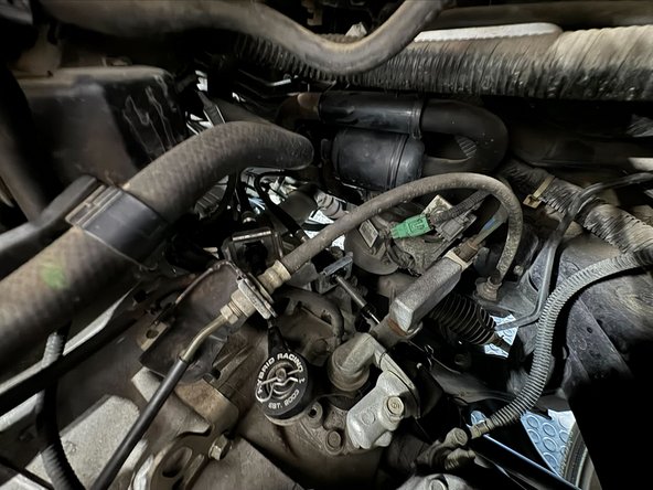 Reach behind the Intake-Box and pull it off of the Throttle-Body