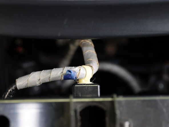 Once it pulls out, remove the light and wire harness clip.