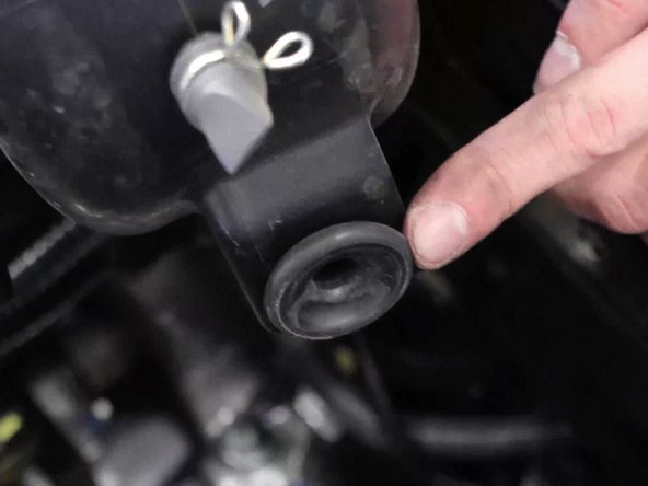 Grab the bottom airbox and pull upwards, the lower section is held in place by a grommet.