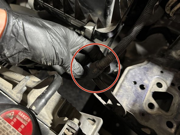 Reconnect the starter wire harness to its mounting tab