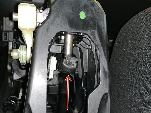 Pull the LH side retaining ring and slide the cable off the pin.