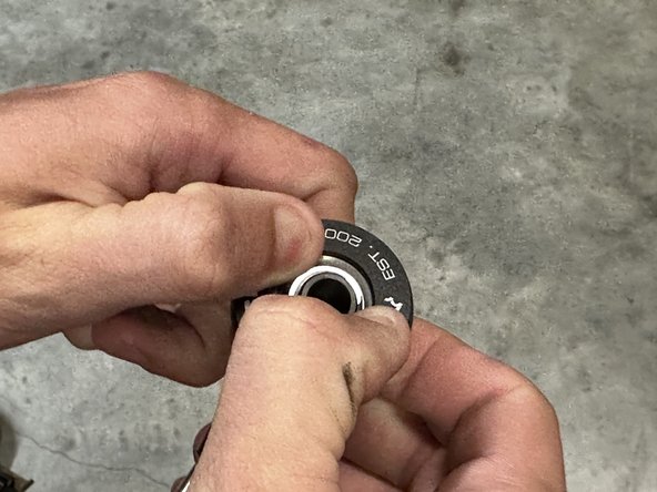 The base of the bearing insert says BOTTOM. This part should sit flat against the transmission.