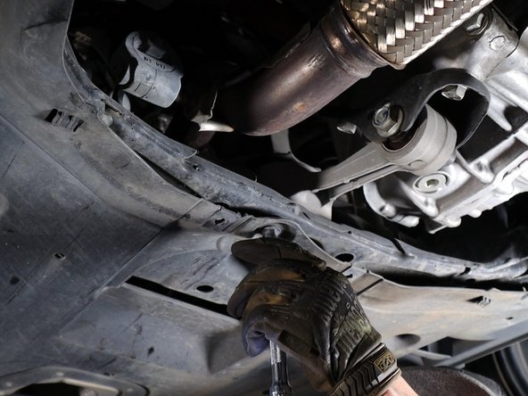 Once the aluminum tray has been removed, you can then unclip the rear section and let it hang down. It is not necessary to remove the entire panel.