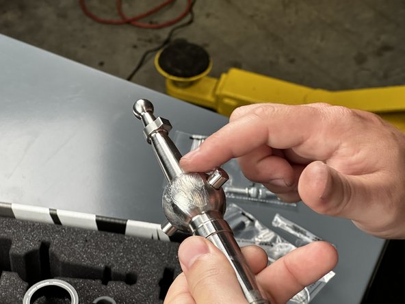 Apply one tube of grease around the outside of the center ball. Be sure to spread it evenly with your finger.