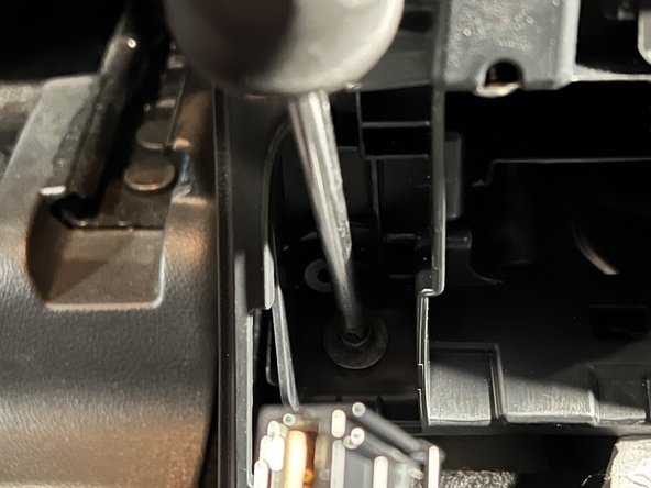 Remove the two rear mounting screws from the base of the console.