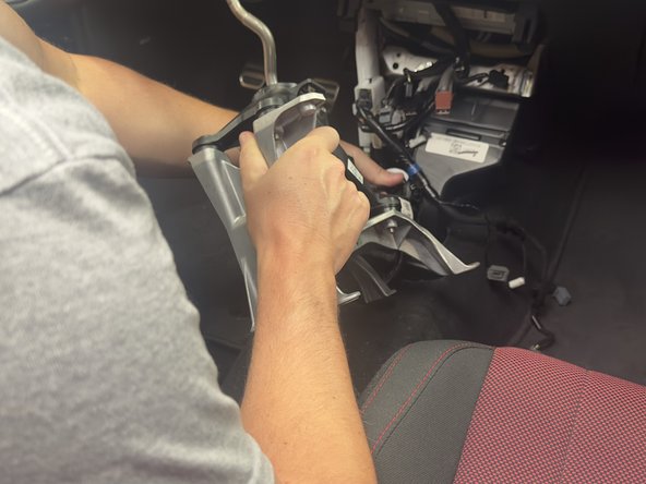 Remove the factory shifter assembly and shifter base from the chassis. You will not reuse this.