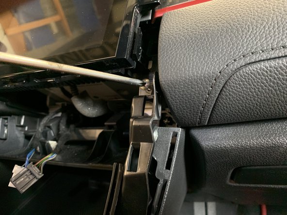 Next, remove the center console screw.