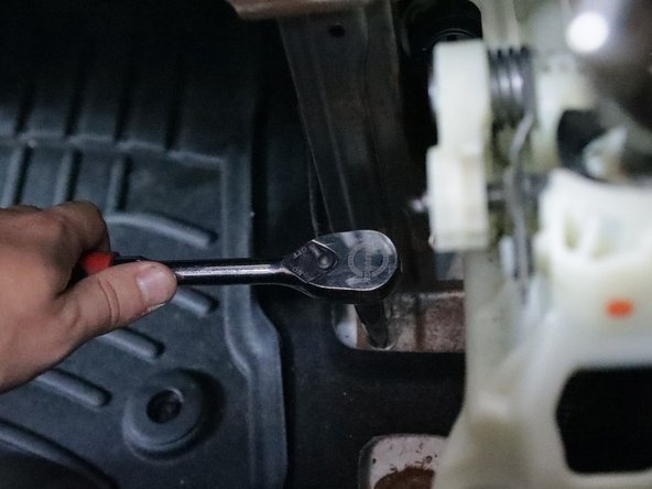 Unbolt the front lower bracket and remove the plastic AC duct.