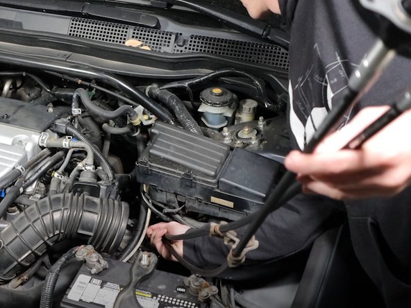 Similar to the way the cables came out, insert them through the engine bay, above the transmission and subframe.